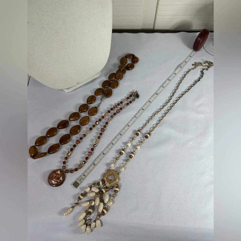 Three neutral tone layering style statement necklaces